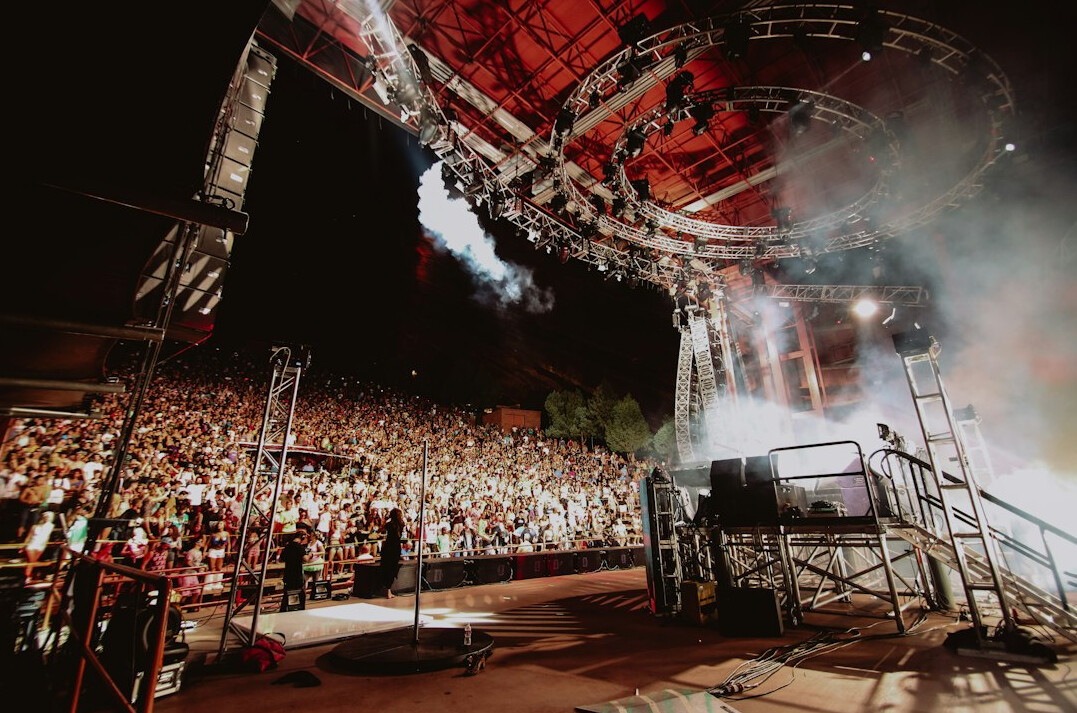 Live concert stage with broadcast camera crane and lighting